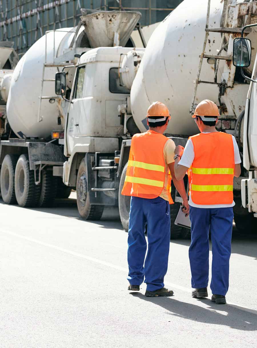 two men and truck mixers ready for industries served