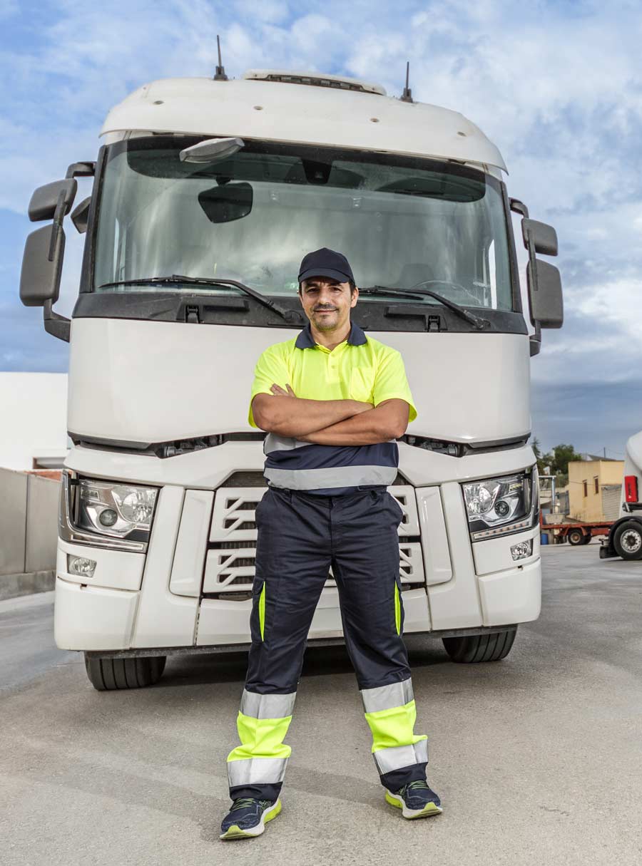 driver in front of a truck ready for industries served